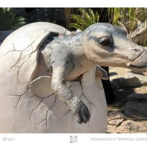 Baby dinosaur hatching from egg.