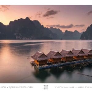 A group of small houses on stilts in the middle of water.